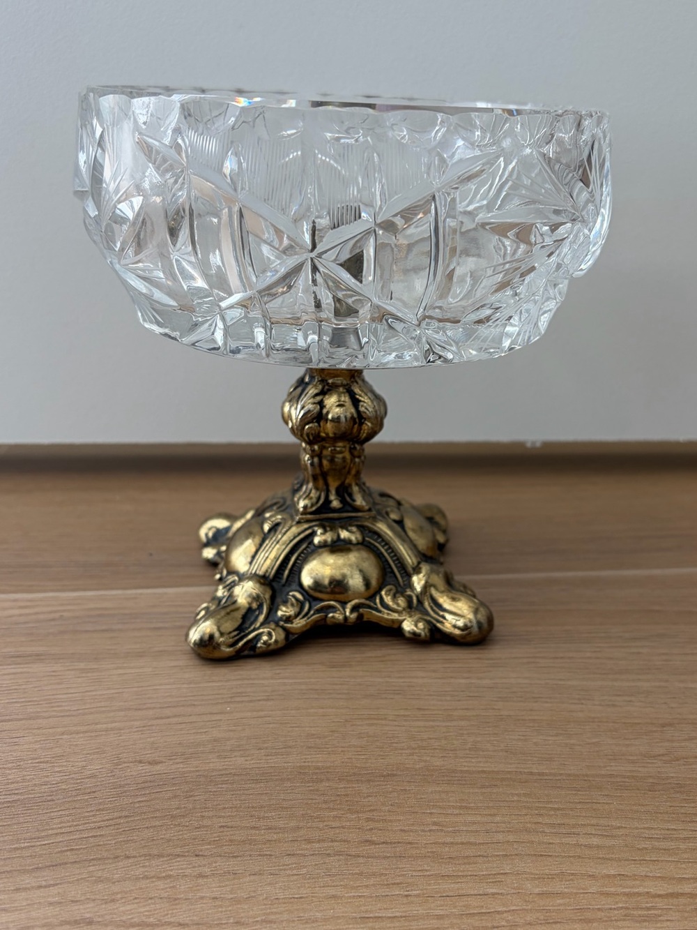 Hollywood Regency style cut crystal compote bowl on a ornate metal pedestal base